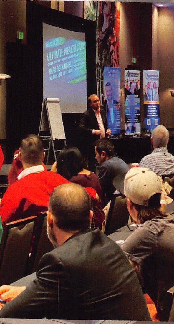 Bill Walsh presenting at the front of a Rainmaker Summit training room
