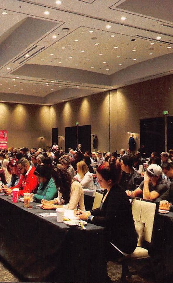 Entrepreneurs gathered in a ballroom at a Powerteam event