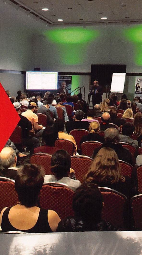 Attendees listening at a Rainmaker Summit session