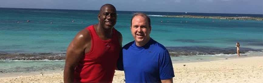 Bill Walsh with Magic Johnson on a beach